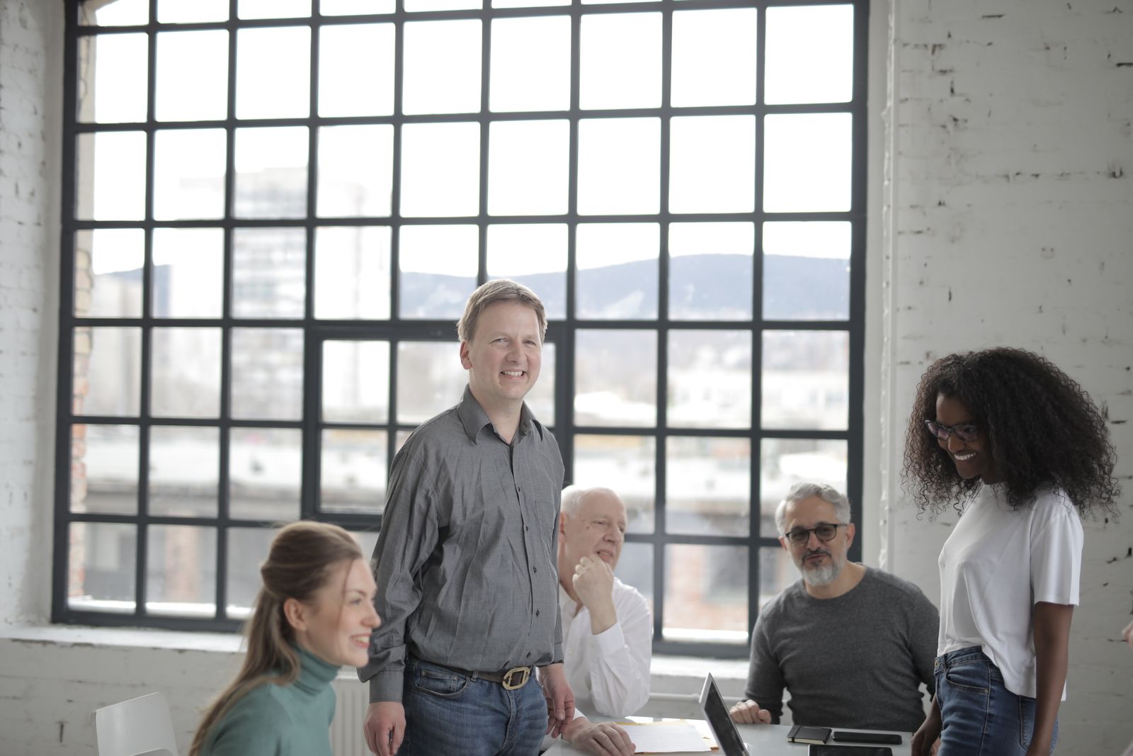 A diverse group of smiling colleagues collaborating in an office